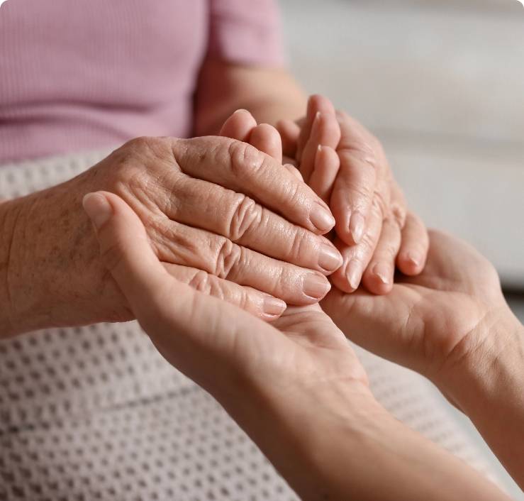 image of elderly person's hands holding young person's hands